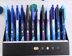 Detailed box display of 12 zodiac themed retractable gel pens with starry sky gradient