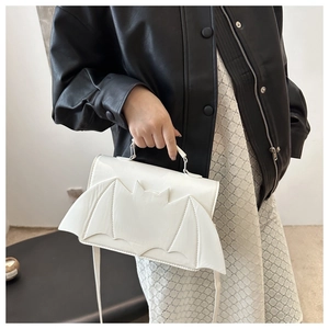 White bat-shaped handbag with wings in PU leather styled with black leather jacket