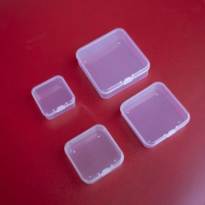 Detailed view of four transparent PP plastic storage boxes in various sizes on red background