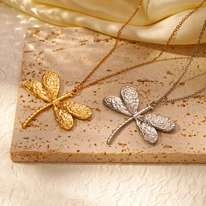 18K gold and silver dragonfly pendant necklaces with hammered texture on beige stone