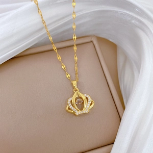 Detail of gold crown pendant with sparkling dancing zirconia and flat lip chain link