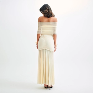 Back view of beige off-the-shoulder mesh maxi dress with backless slit detail