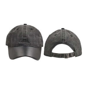 Detail view of washed vintage baseball cap featuring premium leather brim and metal buckle