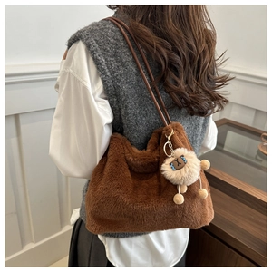 Back view of plush brown tote bag with cute lamb charm and leather shoulder strap