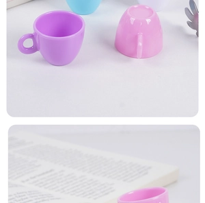 Macro shot of mini colorful plastic tea cups for dollhouse accessories in purple and blue