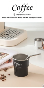 Close-up of black stainless steel camping mug with step design and metal stirring spoon