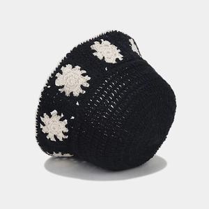 Handmade crochet bucket hat in black with white floral patterns for sun protection