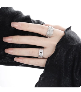 Detailed view of S925 sterling silver rings with lace edges and a black gemstone inlay