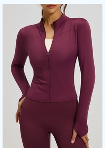 Close-up of athletic jacket with thumb holes and ergonomic stitching on dark purple fabric