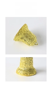 Detail of vintage gold Christmas bell with intricate star patterns and maple vine motifs