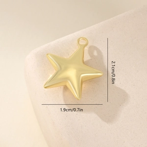 Detail view of golden star pendant with dimensions 2.1cm x 1.9cm on stone base