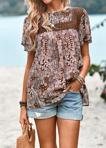 Detailed close-up of brown floral print top with intricate lace trims on the sleeves