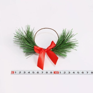 Christmas pine needle napkin ring with a red bow, measuring 15-18cm on white background