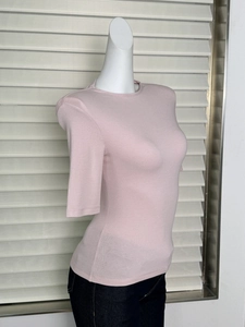 Detail shot of slim fit light pink ribbed knit T-shirt showing side silhouette on mannequin