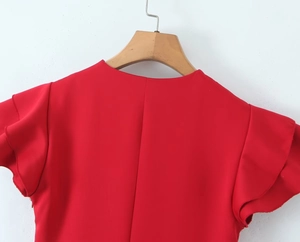 Detail of red tiered dress featuring flutter sleeves and a classic round neckline