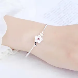 Silver-plated open bangle with cherry blossom design and pink gemstone accent