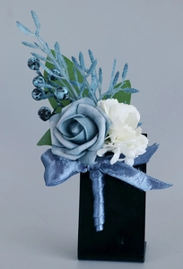 Detail of blue and white silk rose boutonniere with berries and blue ribbon wrap