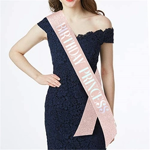 Close-up of pink glitter sash featuring white Birthday Princess text on model