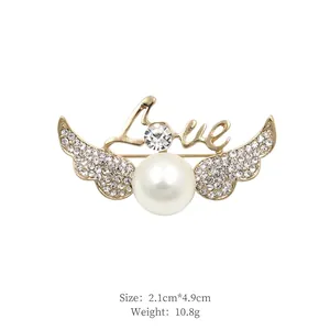 Detail view of angel wing brooch with Love text and pearl, size 2.1cm x 4.9cm