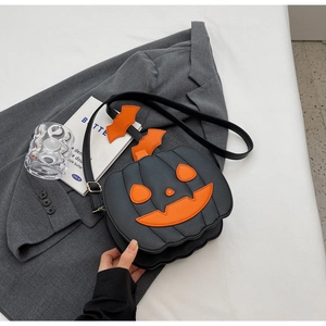 Close-up of Halloween pumpkin bag featuring orange bat wings and quilted faux leather