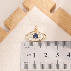 Macro view of Evil Eye pendant with zircon inlay and measurement scale for size reference
