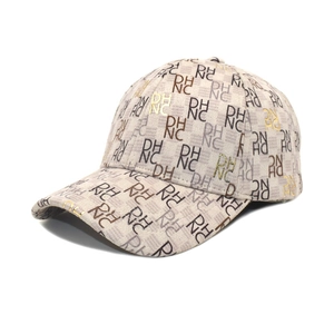 Beige baseball cap with monogram RH NC print and metallic gold stamping accents
