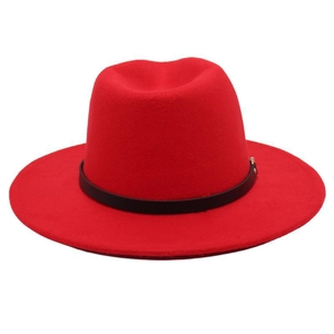 Detail of red wide brim fedora hat featuring a stylish black decorative ribbon band