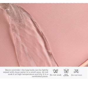 Detailed close-up showing the water-resistant pink fabric with hydrophobic water droplets