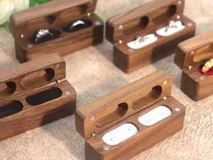 Detail of walnut wood double ring box with magnetic closure and soft flocking lining