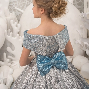 Sparkly silver sequined flower girl dress with a large blue back bow and lacing
