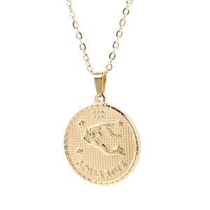 Detailed view of golden Aquarius zodiac pendant with embossed symbol on polished metal