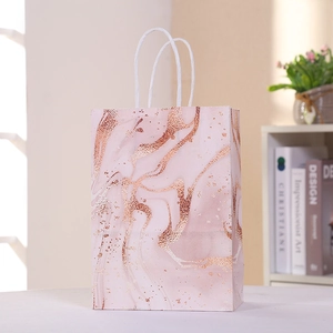 Pink marble texture paper gift bag with rose gold foiling and white cotton handles
