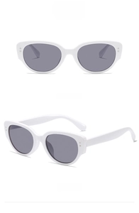 Detail view showing white cat eye frame with gray lenses and metal side accents