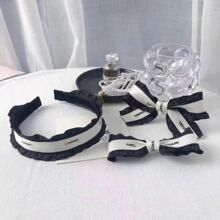 Detailed view of lace bow hair clips and headband set with ribbon in black and white