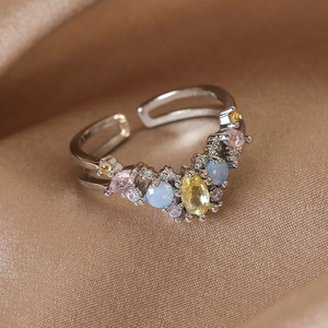 Macro shot of silver V-shaped adjustable ring featuring multicolor zircon and opal stones