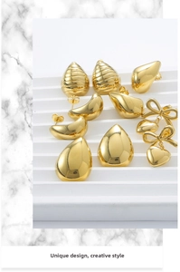 Detailed view of varied 18K gold plated geometric stud earrings on a marble display