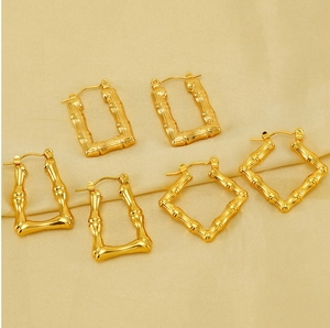Detailed view of three pairs of vintage gold bamboo texture geometric hoop earrings