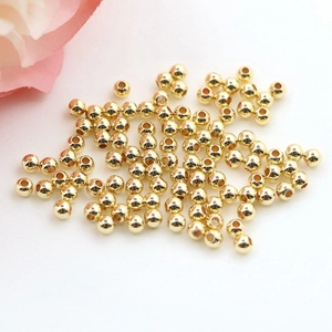 Macro view of 14K gold filled spacer beads with smooth metallic finish for DIY jewelry