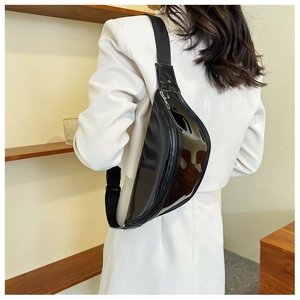 Detail view of the sleek black glossy finish and metallic zipper on the PVC chest bag