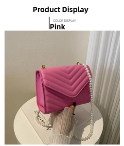 Detailed view of pink quilted crossbody bag with luxury pearl strap and golden metal hardware