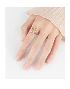 Close-up of a silver sunflower and bee spinning ring on a finger for stress relief