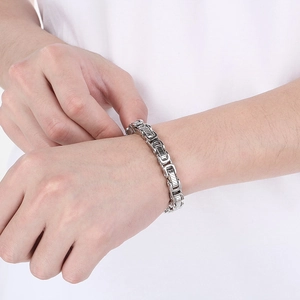 Detail shot of silver stainless steel Byzantine chain bracelet worn on male wrist
