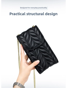 Close-up of black leather crossbody phone bag with V-quilted texture and gold chain