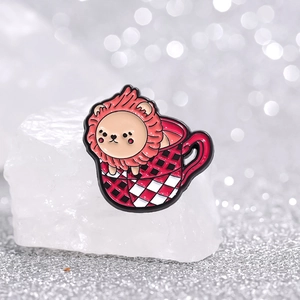 Creative enamel lion in a red plaid teacup pin displayed on white crystal stones