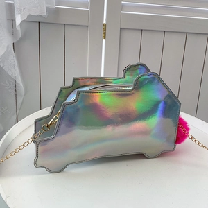 Detail of laser-effect car-shaped crossbody bag with gold chain and pink pompom