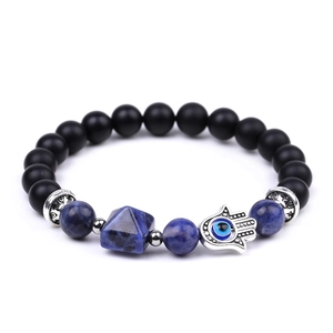 Close-up of Hand of Fatima charm with Evil Eye on amethyst pyramid beaded bracelet