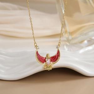 Gold-plated eagle necklace with red enamel wings and pink marquise stone on white base
