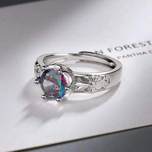Close-up of vintage silver ring with colorful round zircon and cross pattern details