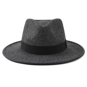 Detail of dark grey felt fedora hat featuring black ribbon and textured brim edge