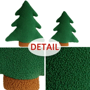 Macro detail of green fleece fabric texture on a Christmas tree shaped plush cushion
